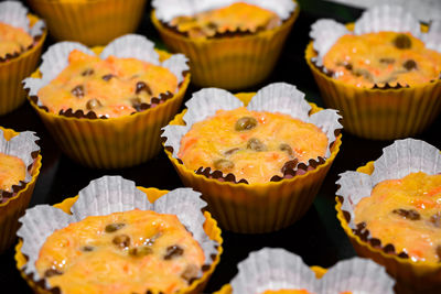 The process of making carrot muffins. dough for cakes in paper molds on a black background. 