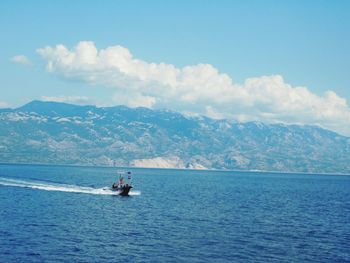 Boat sailing on sea against sky