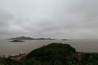 View of calm sea against cloudy sky