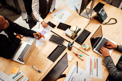 High angle view of business colleagues working on table