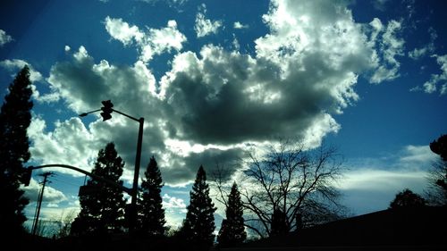 Low angle view of silhouette man against sky