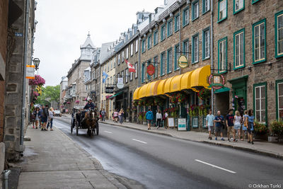 People on city street amidst buildings