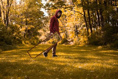 Man carrying mirror in forest