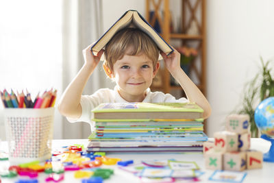 Portrait of girl playing with toy blocks on table