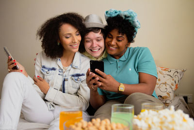 Portrait of young woman using mobile phone at home