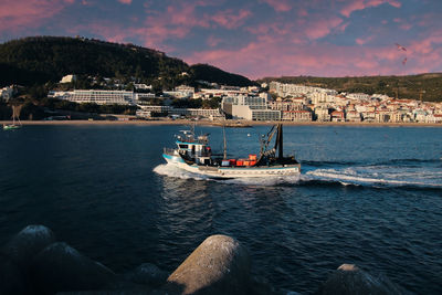 Scenic view of sea by buildings against sky