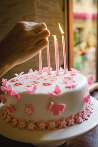 Close-up of hand holding ice cream cake