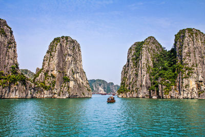 Panoramic view of rocks in sea against sky