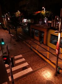 Man walking on illuminated street at night