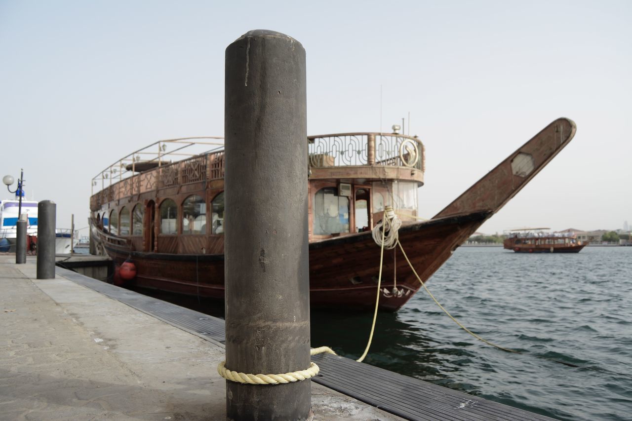 transportation, nautical vessel, mode of transportation, sky, water, day, nature, clear sky, no people, sea, outdoors, architecture, metal, built structure, old, public transportation, waterfront, abandoned, travel