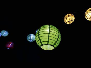 Low angle view of illuminated lights at night