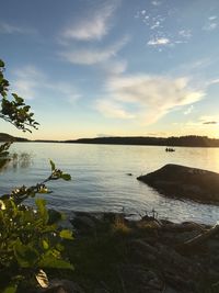 Scenic view of lake against sky at sunset