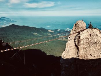 High angle view of sea and mountains against sky