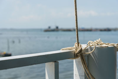 Close-up of rope tied on wooden post