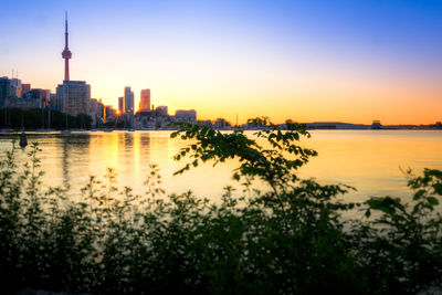 View of city at waterfront during sunset