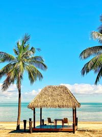 Built structure on beach against blue sky