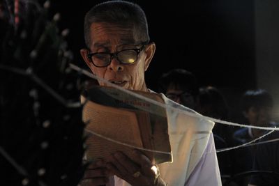 Portrait of a man holding eyeglasses