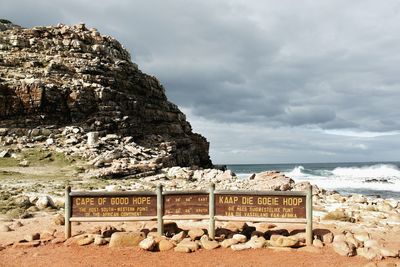 Built structure on rock by sea against sky