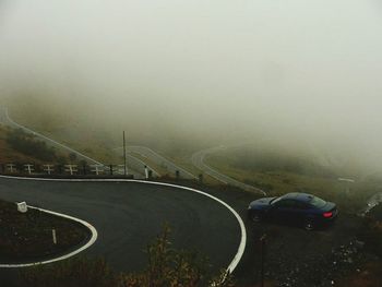 Cars on road during foggy weather