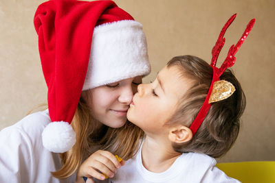 Portrait of smiling girl playing with christmas tree