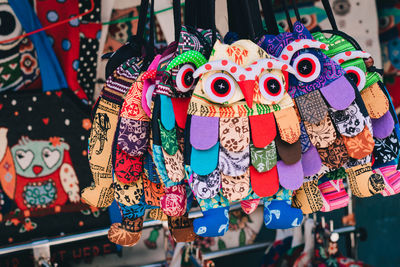 Close-up of colorful toys hanging for sale at market stall