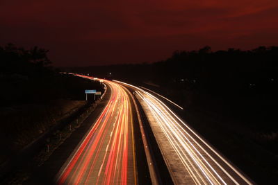 High angle view of light trails on highway at night