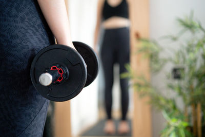 Midsection of woman exercising in gym