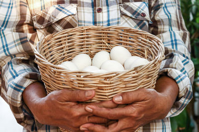 Close-up of man holding ice cream in basket