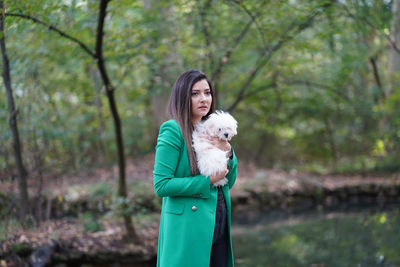 Young woman with dog in the forest