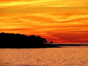 Scenic view of sea against orange sky