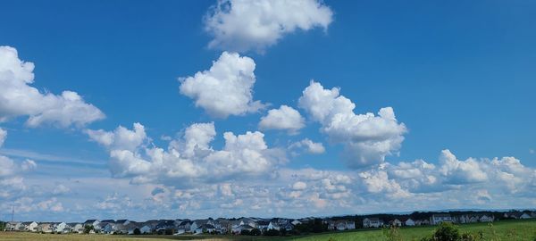 Panoramic view of landscape against blue sky