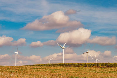 Windmill on field against sky