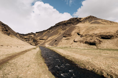 Panoramic view of road amidst mountains against sky