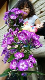 Close-up of girl with pink flowers