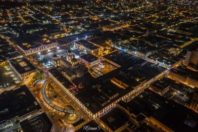 Aerial view of illuminated city buildings at night