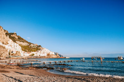 Scenic view of sea against clear blue sky