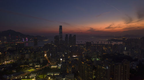 Hong kong  kowloon cityscape view , illuminated cityscape against sky during sunset