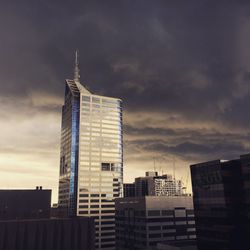 Low angle view of skyscrapers against sky during sunset