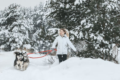 Woman with dog in snow