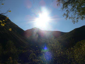 Scenic view of mountains against sky on sunny day