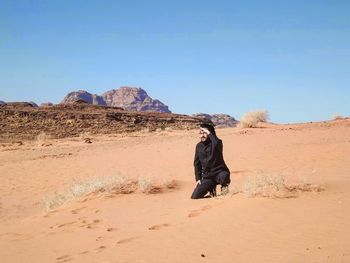 Rear view of a woman in desert