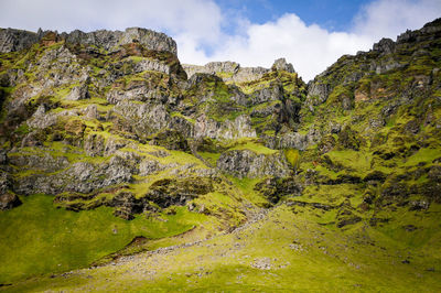 Scenic view of rocks and mountains against sky