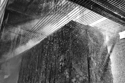 Low angle view of wet window in rainy season