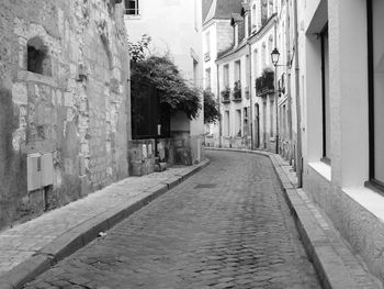 Empty alley amidst buildings in city