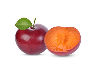 Close-up of orange fruit against white background