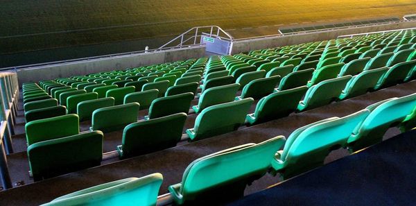 Empty seats at stadium during night