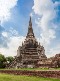 Old temple building against cloudy sky