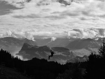 Scenic view of mountains against cloudy sky