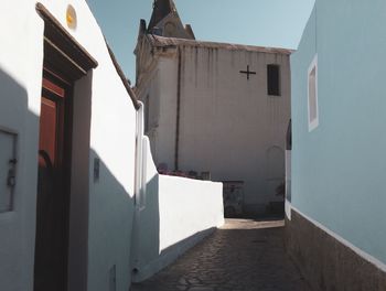 Alley amidst buildings against sky