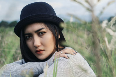 Close-up portrait of young woman in meadow